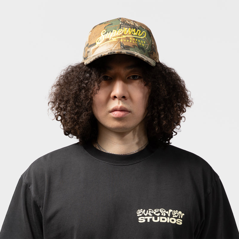 SUPERVSN STUDIOS(スーパーヴィジョンストゥディオス)｜ENERGY CO CAMO HAT(エナジーCOカモハット)｜【公式通販 UNION TOKYO】｜ユニオントーキョー